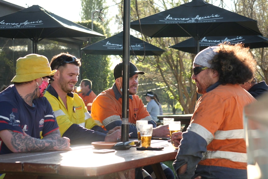 a group of young men having a beer at the pub