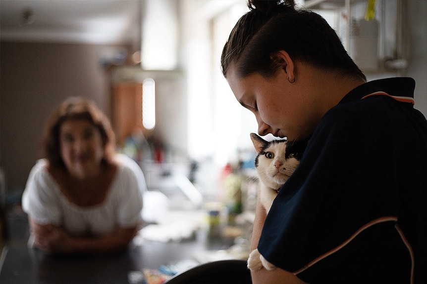 Amelia cuddling a cat