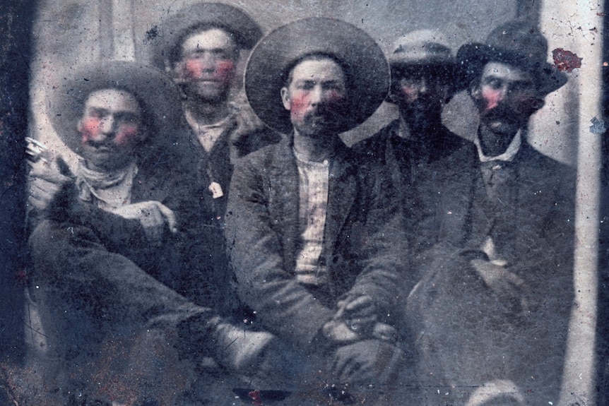 Billy the Kid, second from left, and Pat Garrett in a black and white tintype photo