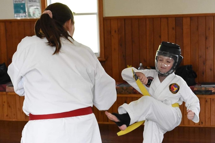Two young students practicing taekwondo