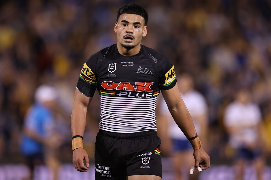 A Penrith Panthers NRL player walks off the field during a 2022 match.