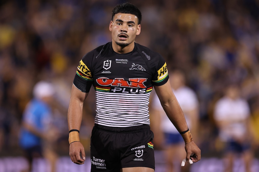 A Penrith Panthers NRL player walks off the field during a 2022 match.