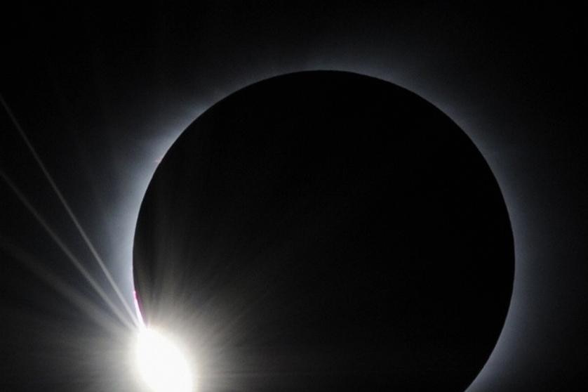 Moon almost completely covers the sun just before totality during a total solar eclipse