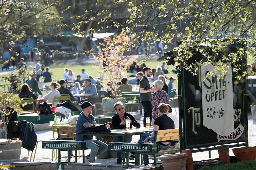 People sit drinking beer in Stockholm.