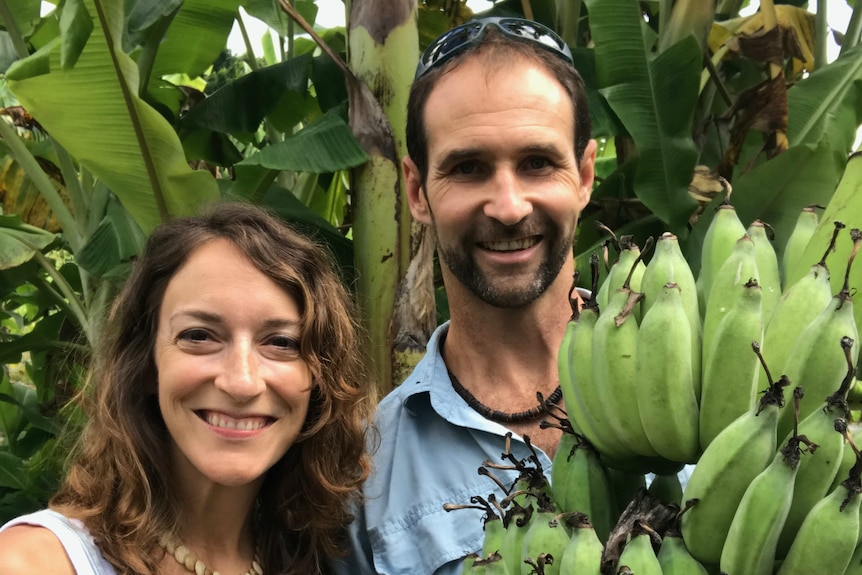 The couple with a huge bunch of bananas.