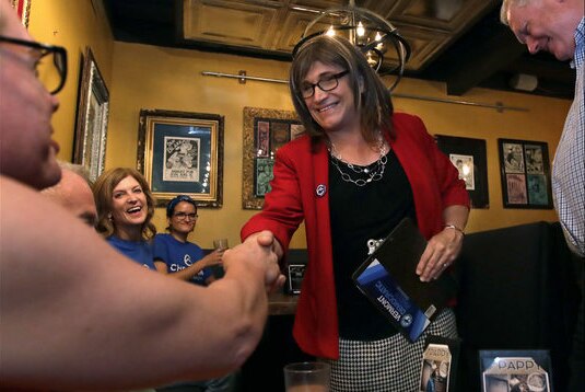 Christine Hallquist smiles and shakes a supporter's hand