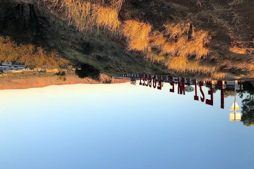 A sign reading 'Lest we forget' has been erected on an Alice Springs hillside.