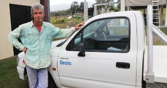 A man standing next to a ute