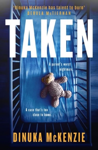 The book cover of Taken by Dinuka Mckenzie, featuring a blue tinted baby's cot with a toy bear