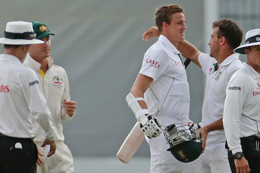 Faf du Plessis and Morne Morkel embrace while Michael Clarke looks on