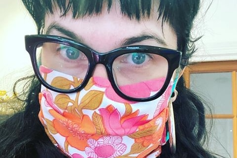 a woman wearing floral face mask