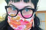 a woman wearing floral face mask