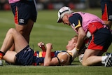 Adelaide's Tom Lynch is helped by medical staff after being injured against Geelong at Port Lincoln.