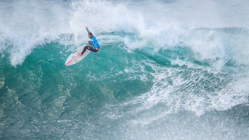 Surfer Courtney Conlogue at the top of a wave at the Bells Beach tournament.