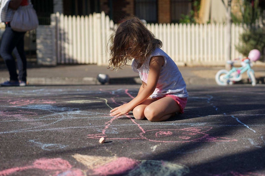 A child drawing on a street.