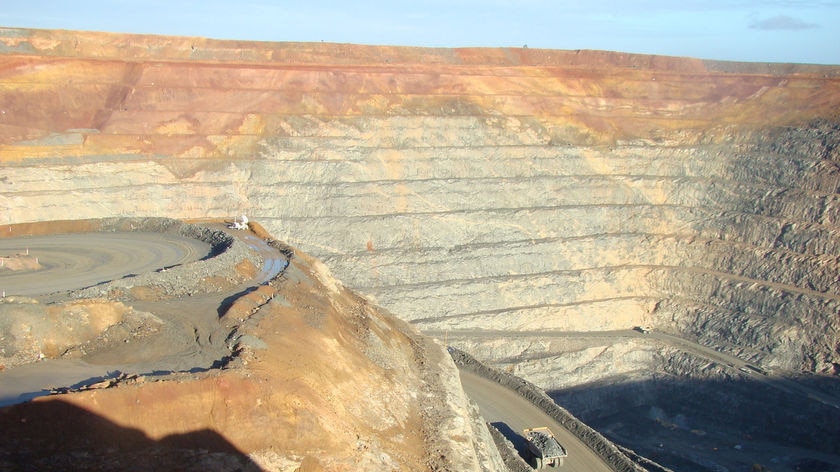Close up of Super pit in Kalgoorlie from edge with truck driving along