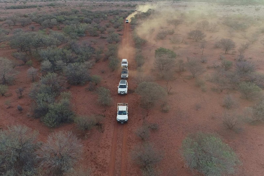 vehicles on a dusty track