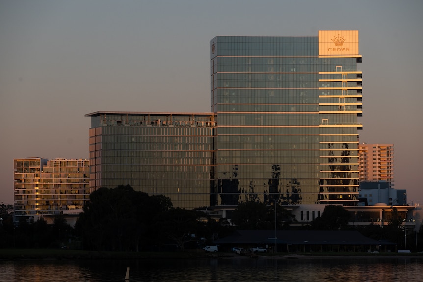 Tall buildings on the banks of a river in the dusk light.