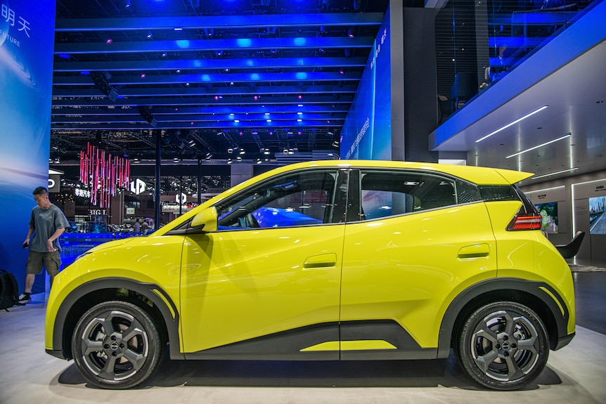 A small yellow car in a showroom