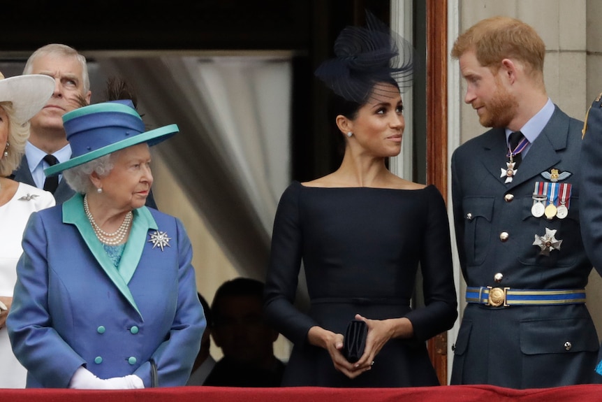 Queen Elizabeth glares at Prince Harry and Meghan as they smile at each other.