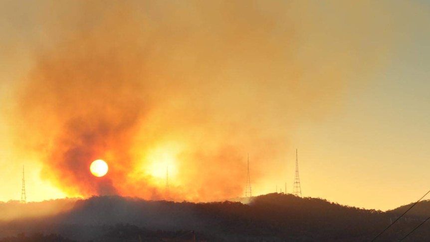 Smoke rises from hazard-reduction fires on Mt Coot-tha