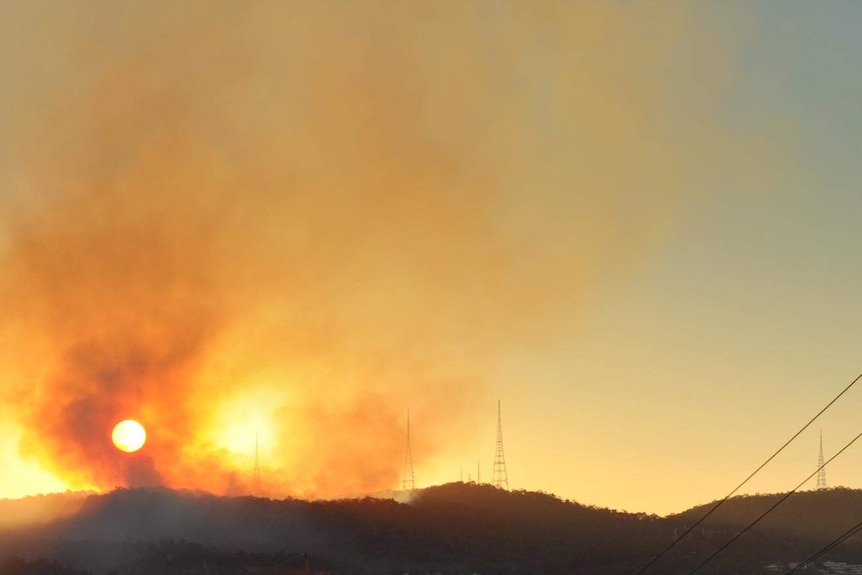 Smoke rises from hazard-reduction fires on Mt Coot-tha