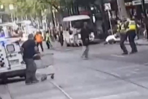 A man pushes a shopping trolley towards Bourke Street terrorist Hassan Khalif Shire Ali.