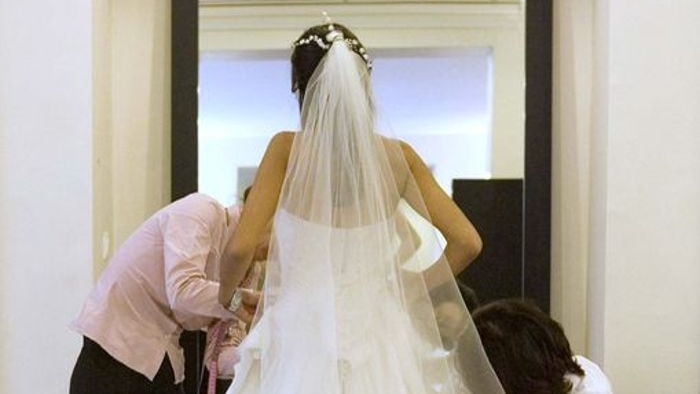 Even in the economic downturn, couples are splurging thousands of dollars on the dream wedding.