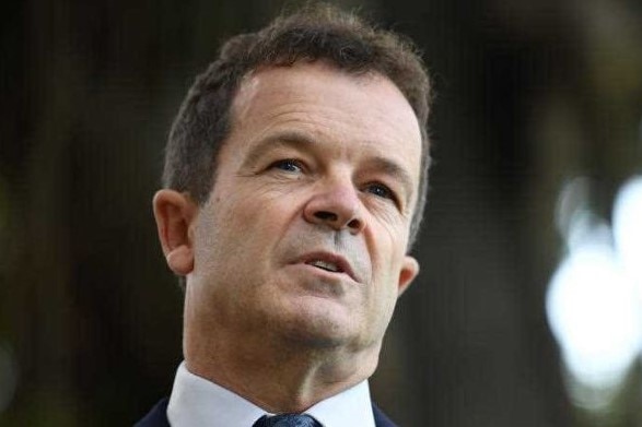 A head and shoulders portrait of a man wearing a suit