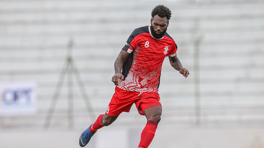 A man from the Solomon Islands playing soccer.