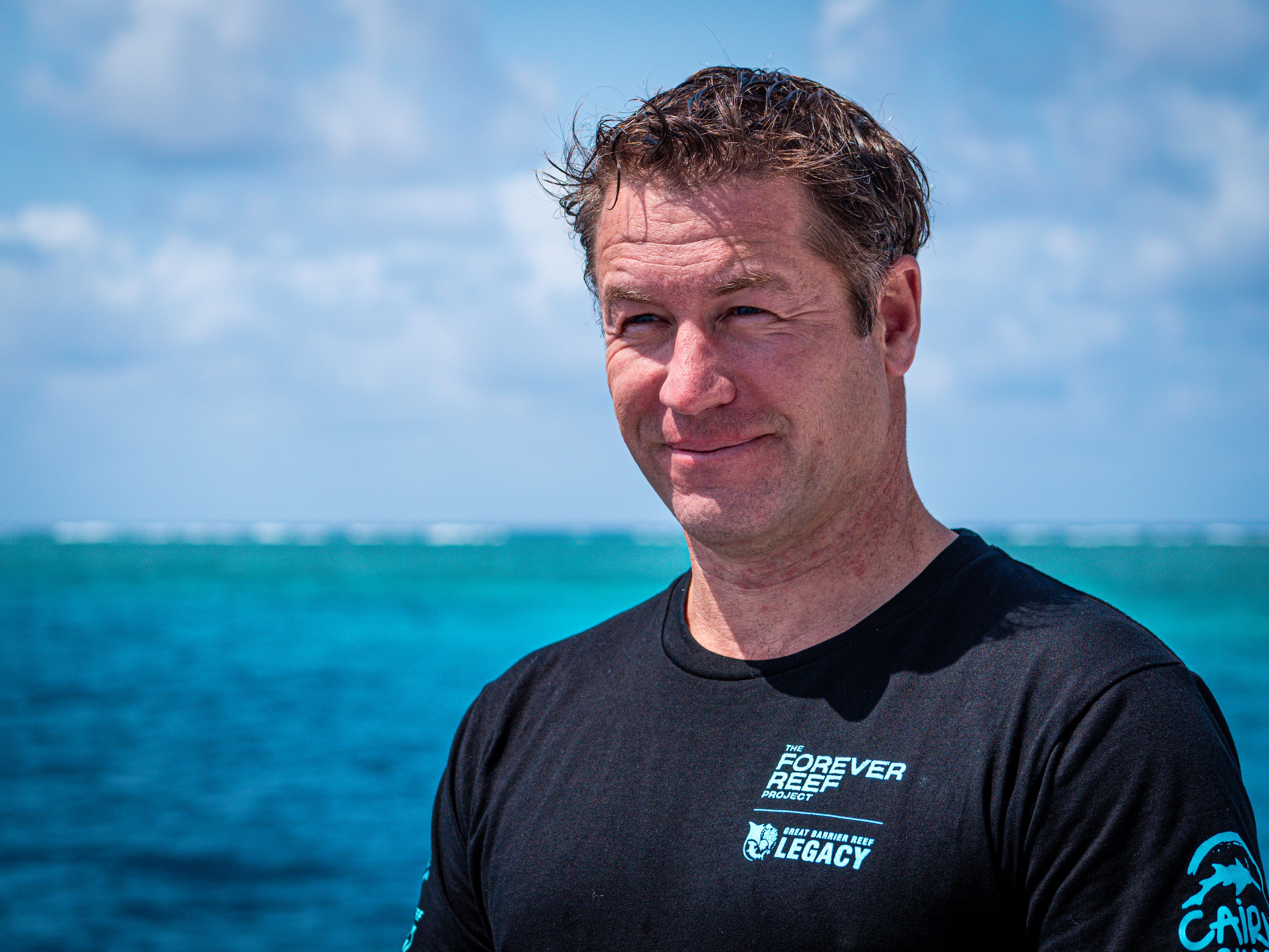 man stares longingly out to sea