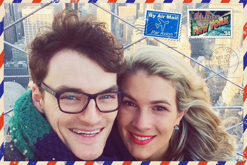 Selfie of young man and woman in New York with skyscrapers in background representing Australian expatriates living overseas.