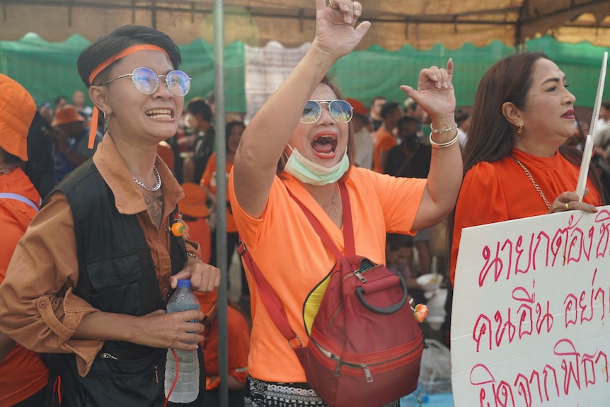 People dressed in orange at a protest 