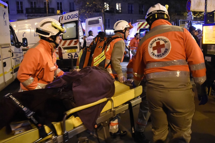 Rescue workers evacuate an injured person at the Bataclan concert hall.