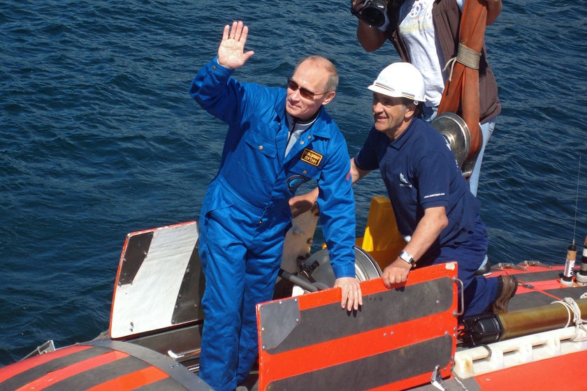Russia's Prime Minister Vladimir Putin waves onboard a "Mir-2" mini-submersible