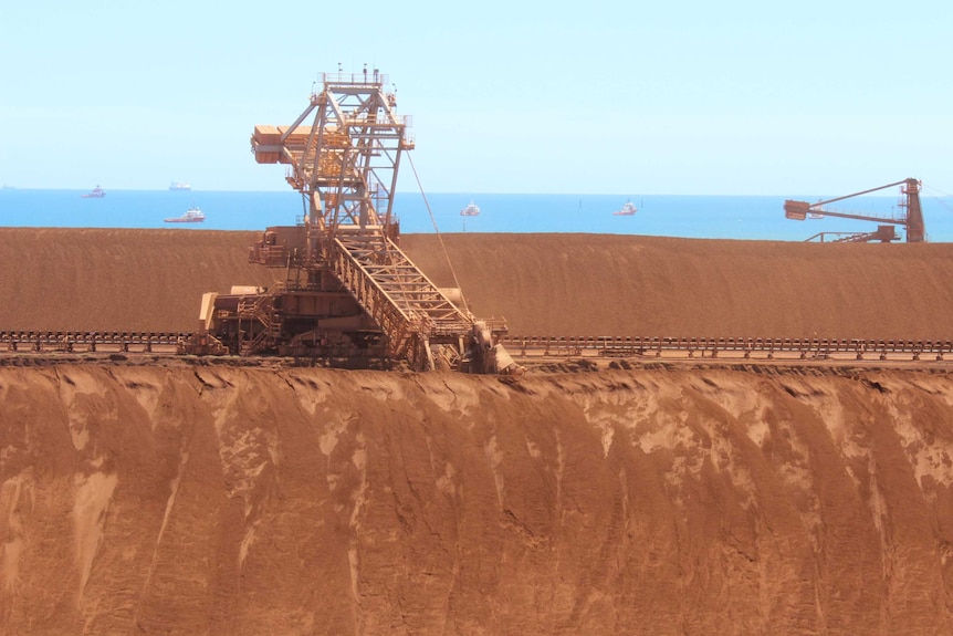 Stockpiles of iron ore with machinery and Parker Point.