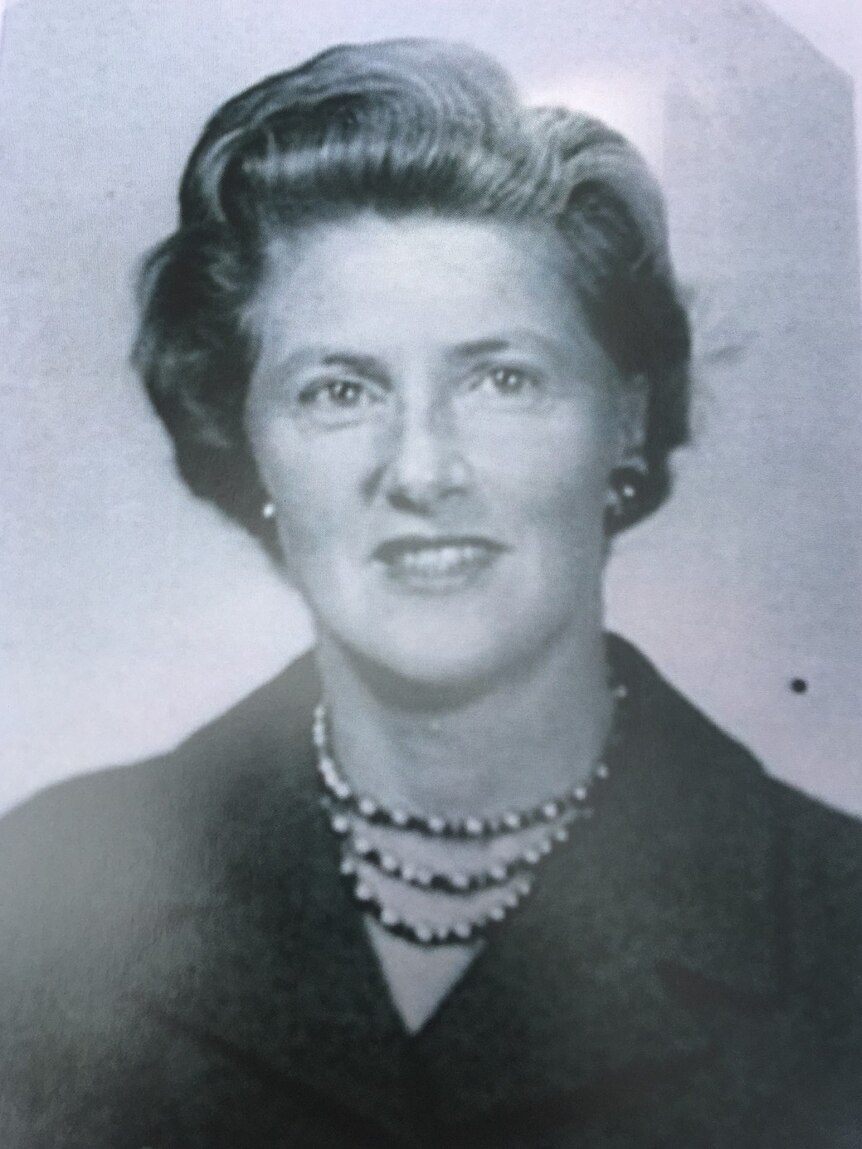 A black and white photograph of Nancy Meyer wearing a black coat and large necklace.