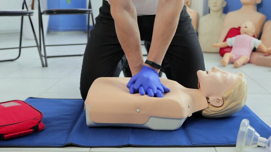 Someone giving CPR on a female looking dummy