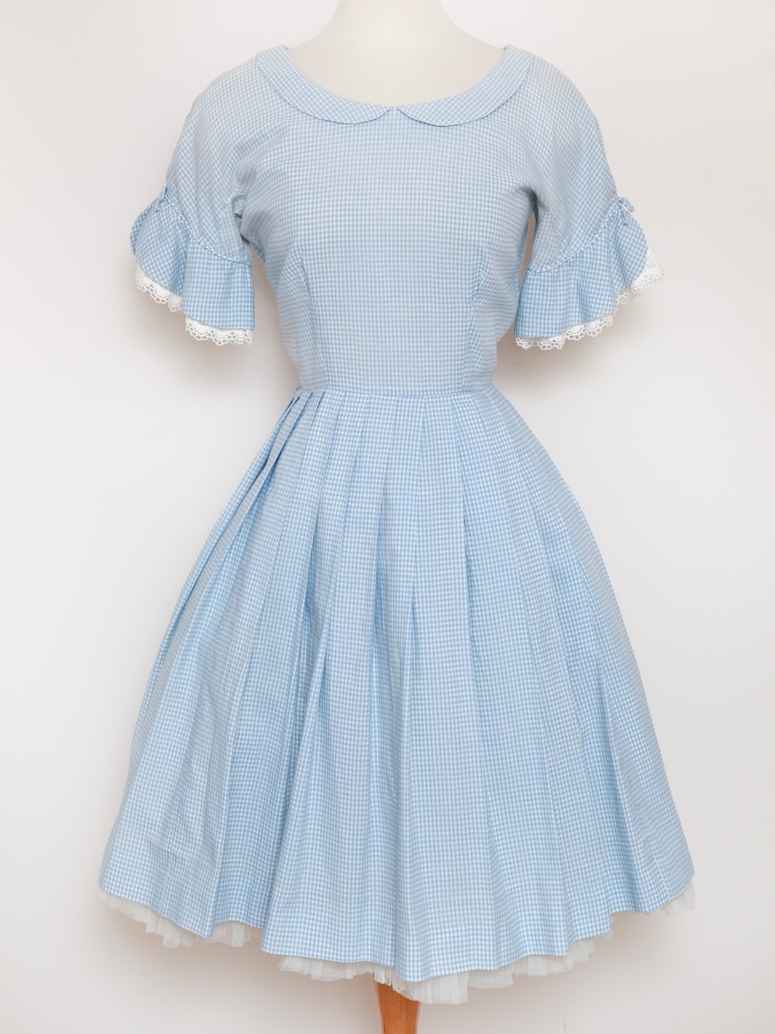 A light blue gingham Ricki Reed dress with a white petticoatt