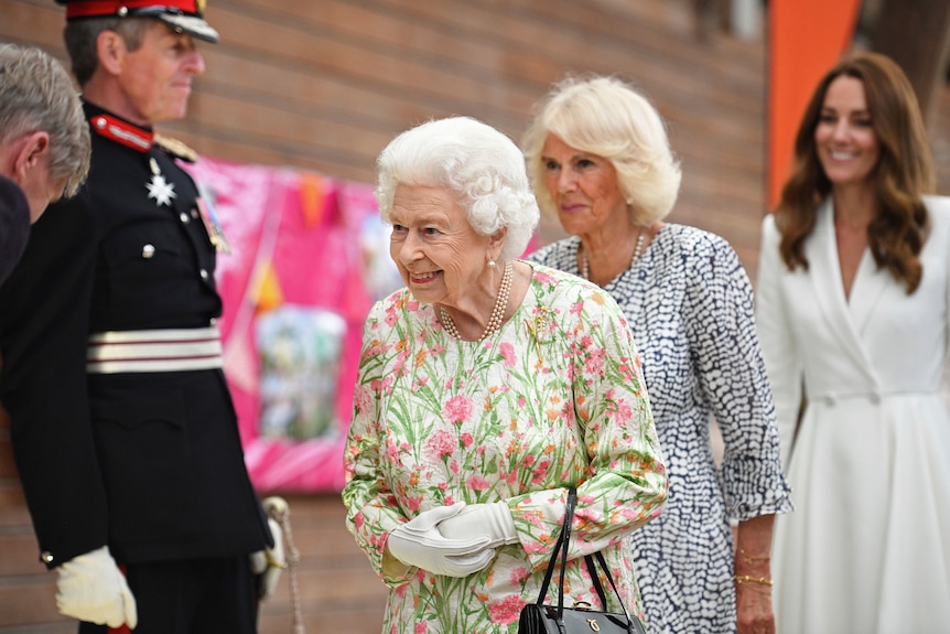 Queen Elizabeth II, Camilla, the Duchess of Cornwall and Kate, the Duchess of Cambridge, attend an event.
