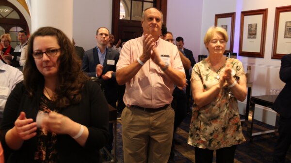 People clap at a No event as the results of the same-sex marriage survey are announced.