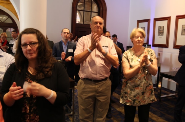 People clap at a No event as the results of the same-sex marriage survey are announced.