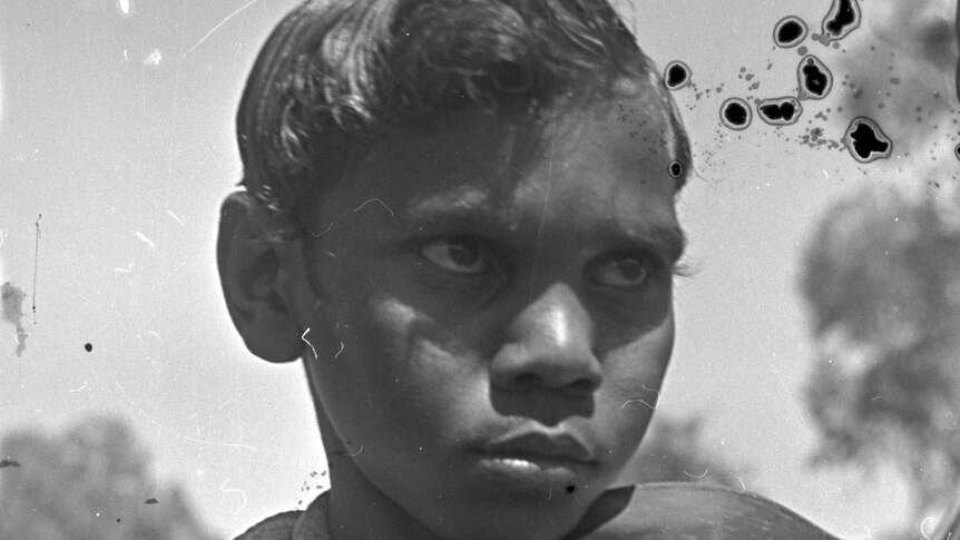 A young indigenous boy plays the violin at the Derby Leprosarium in 1948.