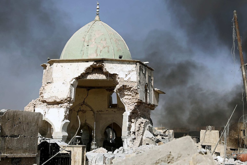 Smoke billows from the ruined Grand al-Nuri Mosque after it was retaken by the Iraqi forces at the Old City in Mosul.