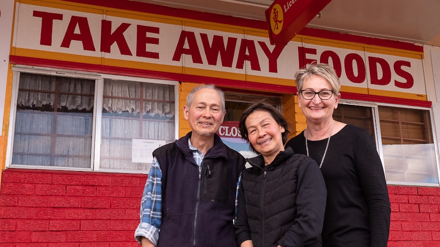 Leanne Anderson with Allan and Patricia Ho at the shop front front their Chinese restaurant.