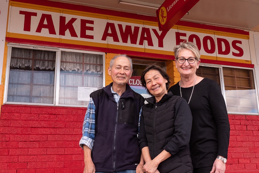 Leanne Anderson with Allan and Patricia Ho at the shop front front their Chinese restaurant.