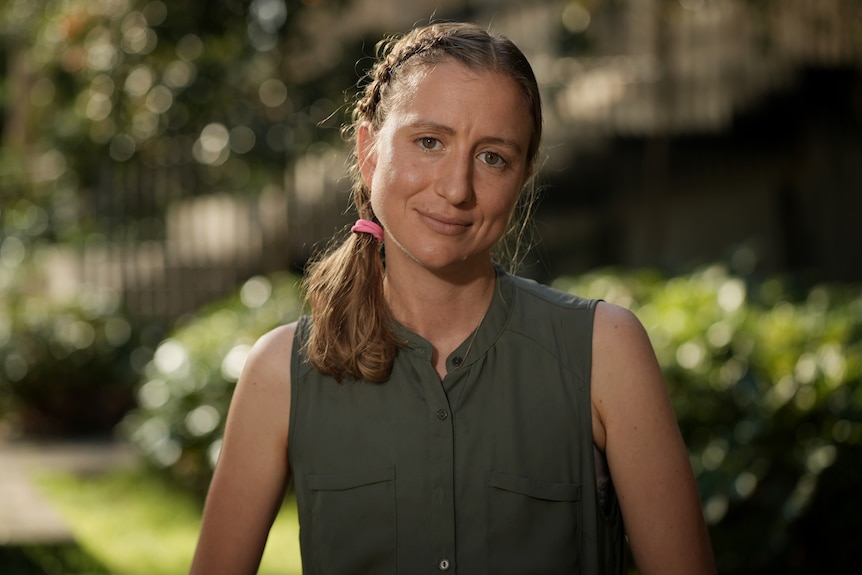 A head shot of a woman outside.