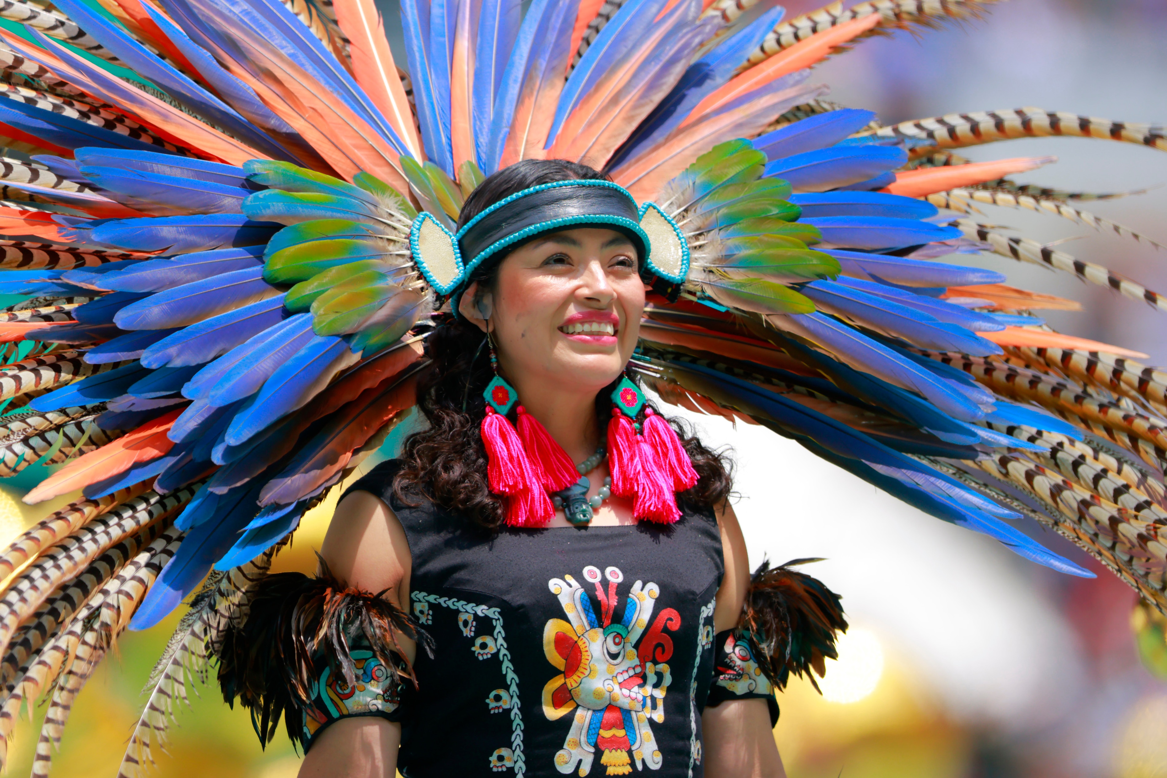A performer wearing a colouful feathered headdress during the World Cup opening ceremony