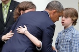 Barack Obama hugs relative of shooting victims after slamming 'minority' for blocking legislation.
