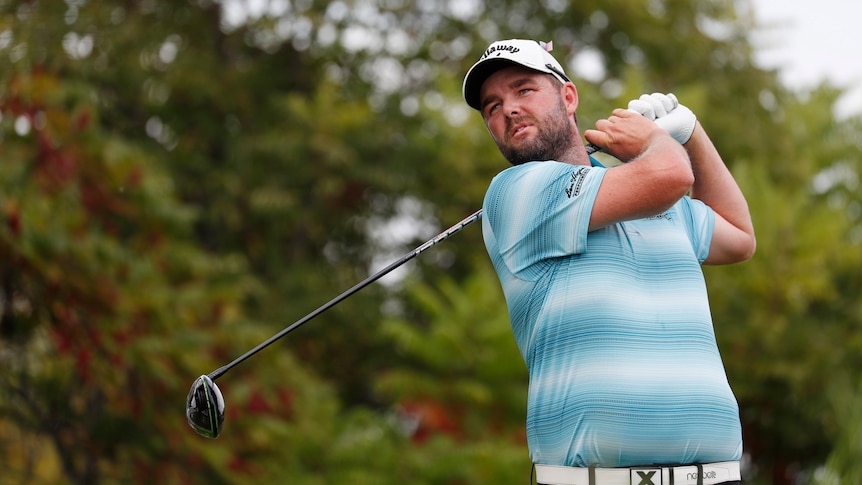 Marc Leishman watches his shot after teeing off.